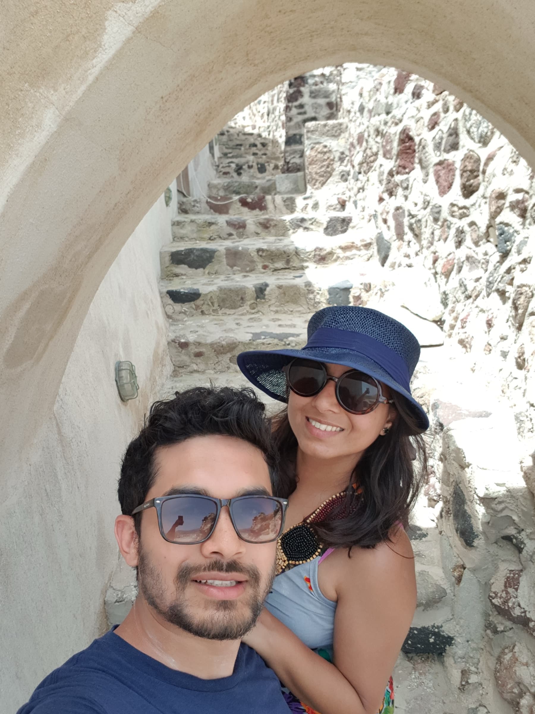 Selfie under a whitewashed stone archway in Santorini